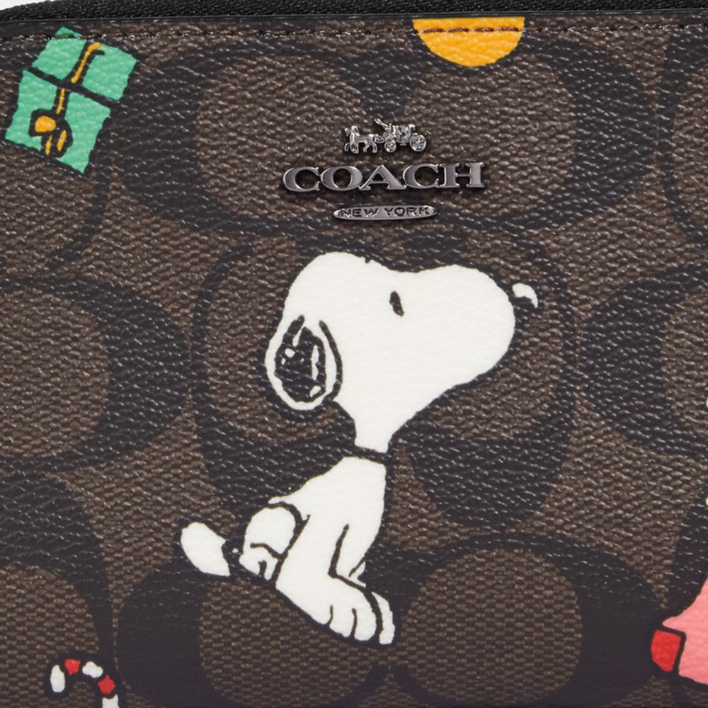 COACH X PEANUTS SMALL ZIP AROUND WALLET IN SIGNATURE CANVAS WITH SNOOPY PRESENTS PRINT