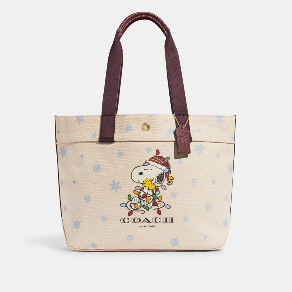 COACH CE854 Coach X Peanuts Tote In Canvas With Snoopy Ice Skate Motif GOLD/NATURAL MULTI