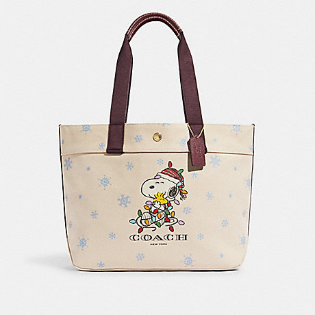 COACH CE854 Coach X Peanuts Tote In Canvas With Snoopy Ice Skate Motif Gold/Natural-Multi