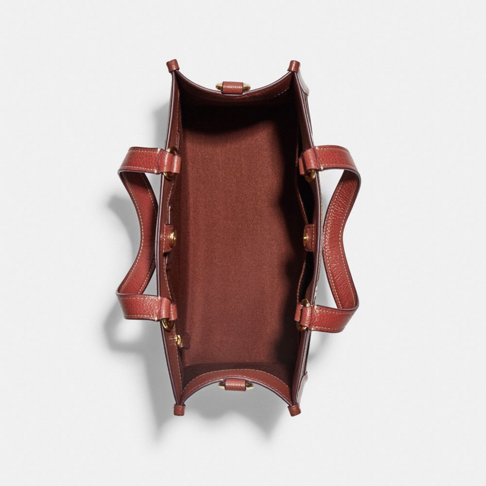 COACH X PEANUTS DEMPSEY CARRYALL IN SIGNATURE CANVAS WITH SNOOPY WOODSTOCK PRINT