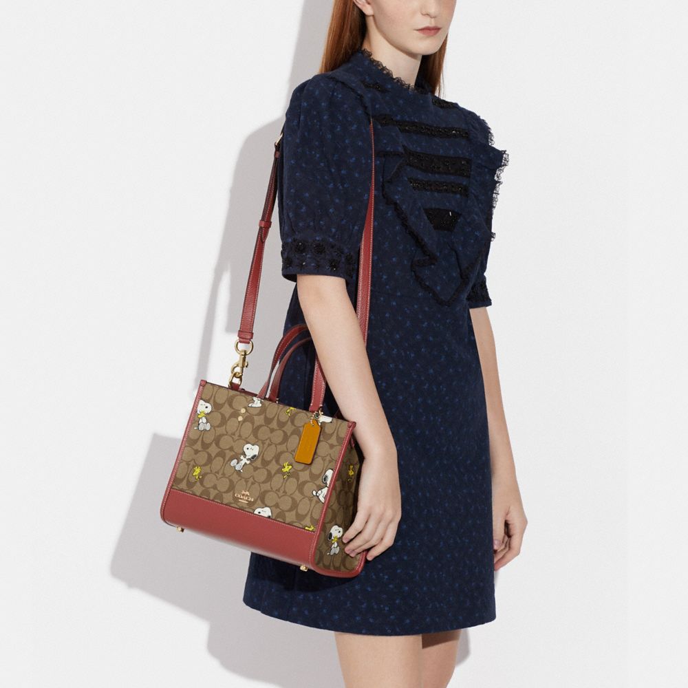 COACH X PEANUTS DEMPSEY CARRYALL IN SIGNATURE CANVAS WITH SNOOPY WOODSTOCK PRINT