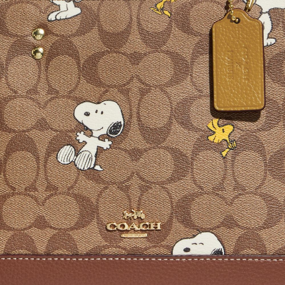 COACH X PEANUTS DEMPSEY CARRYALL IN SIGNATURE CANVAS WITH SNOOPY WOODSTOCK PRINT