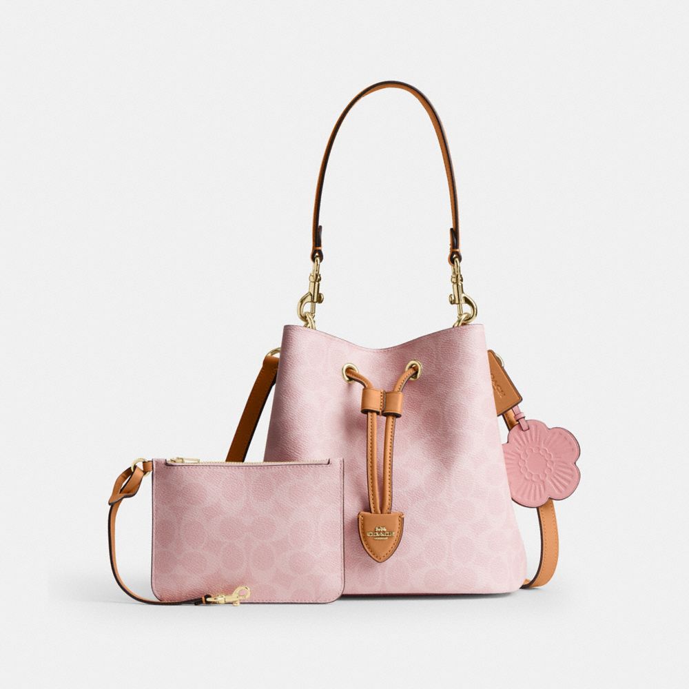 ROWAN BUCKET BAG IN SIGNATURE CANVAS WITH CHARMS