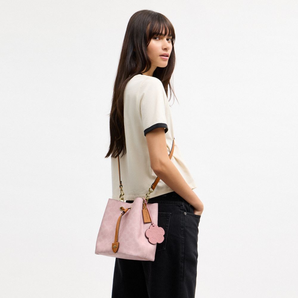ROWAN BUCKET BAG IN SIGNATURE CANVAS WITH CHARMS