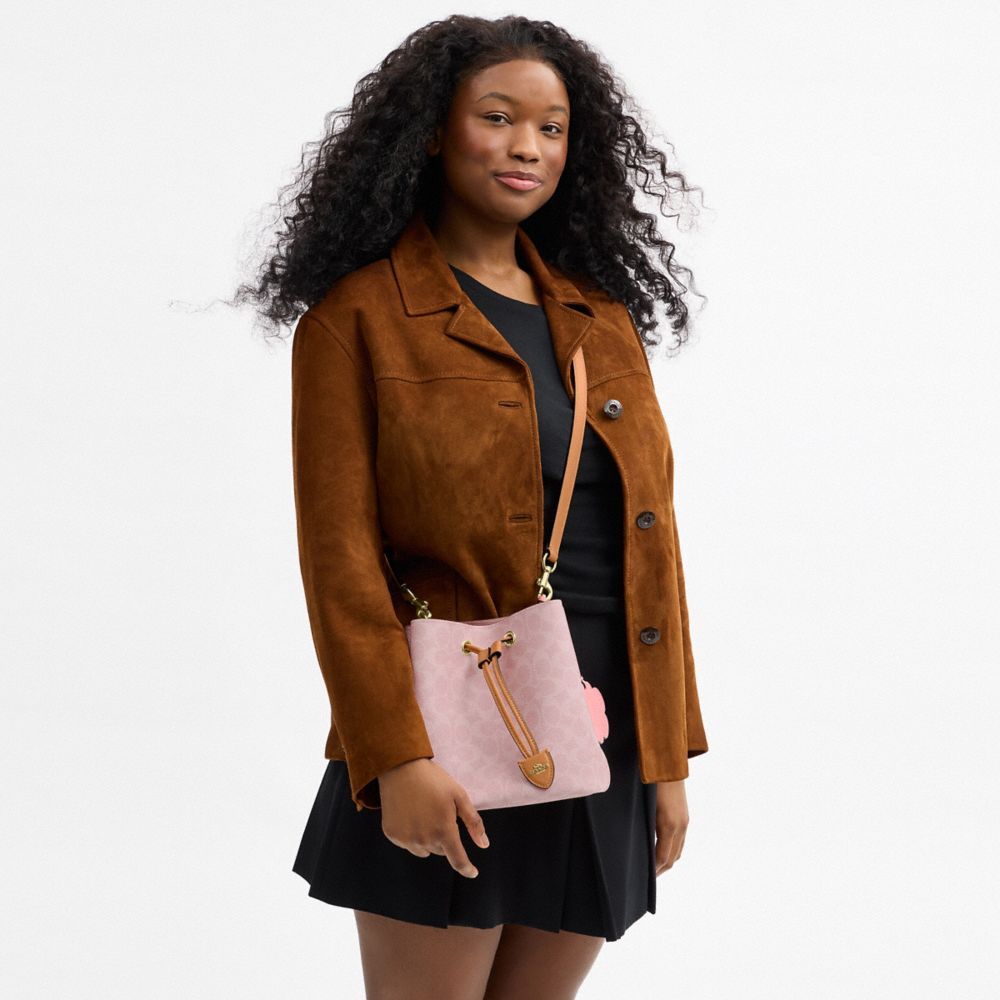 ROWAN BUCKET BAG IN SIGNATURE CANVAS WITH CHARMS