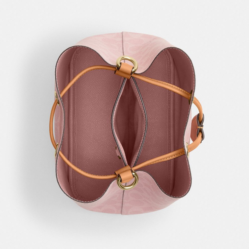 ROWAN BUCKET BAG IN SIGNATURE CANVAS WITH CHARMS