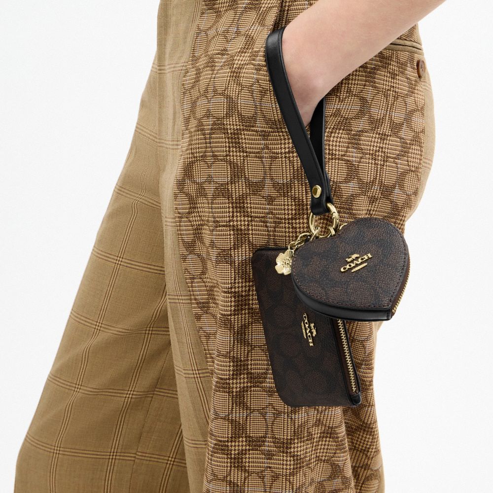 WRISTLET AND HEART POUCH IN SIGNATURE CANVAS WITH CHARM