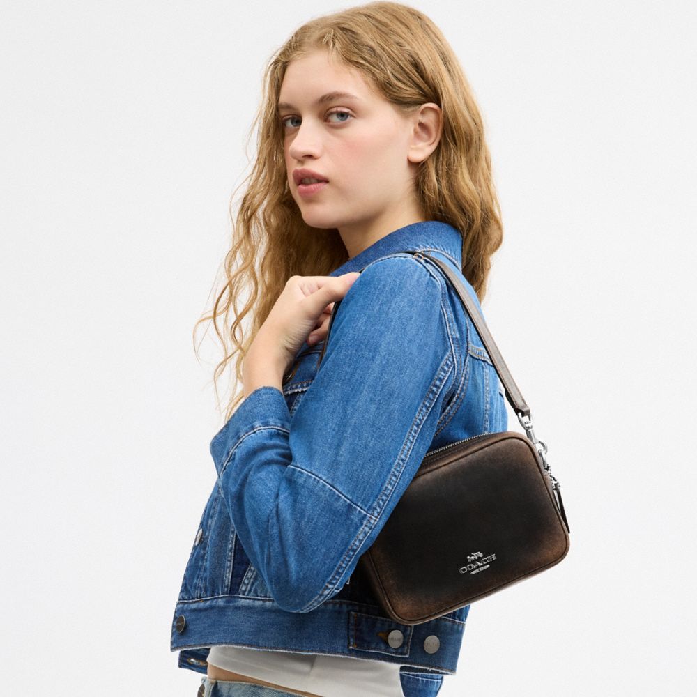 MINI CAREY CROSSBODY BAG IN LOVED LEATHER