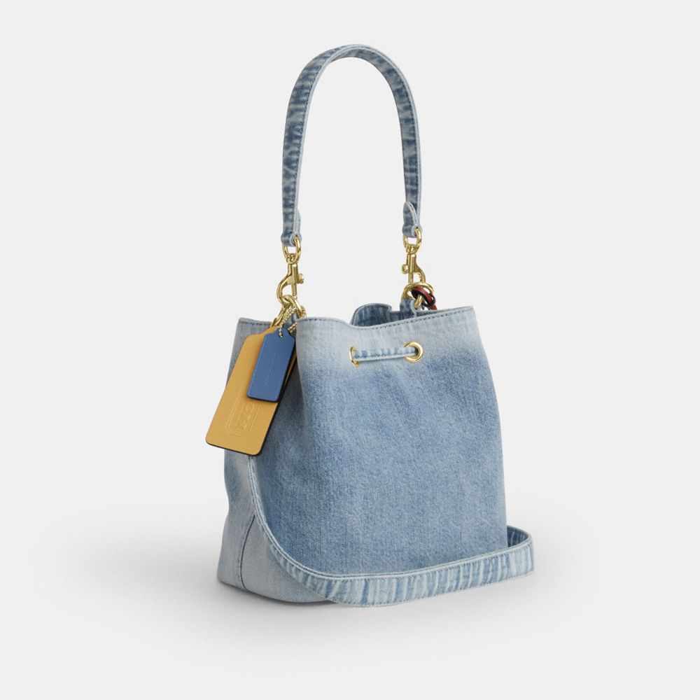 ROWAN BUCKET BAG IN LOVED DENIM WITH CHARMS