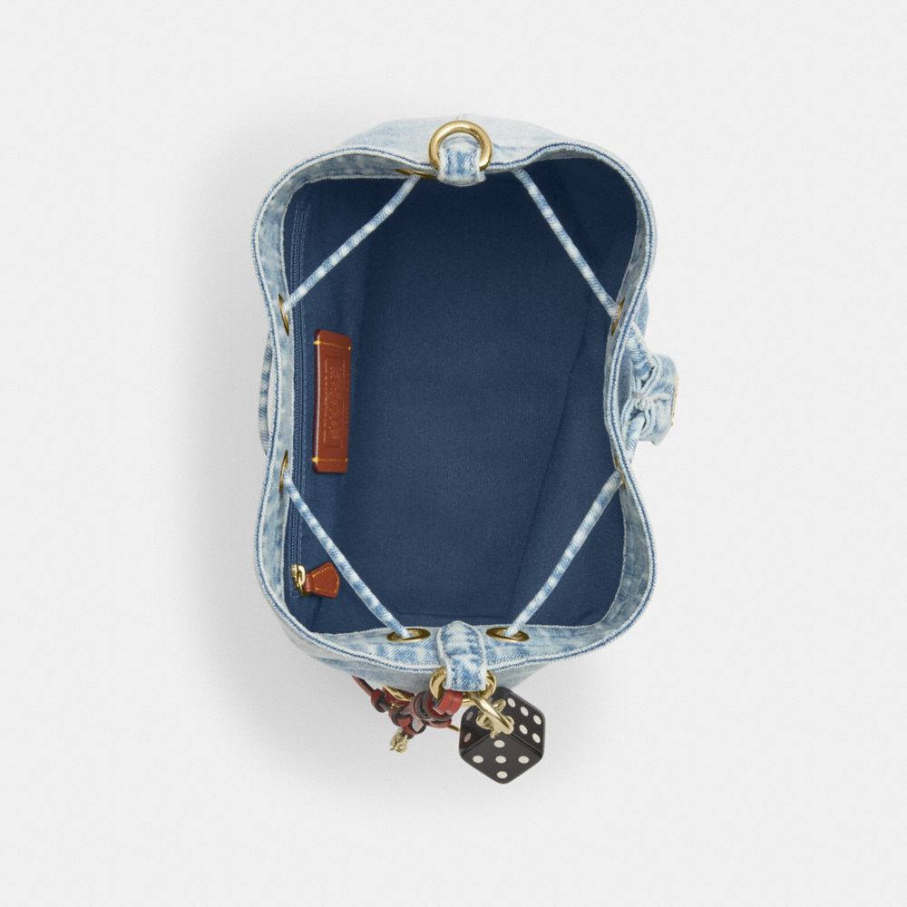 ROWAN BUCKET BAG IN LOVED DENIM WITH CHARMS