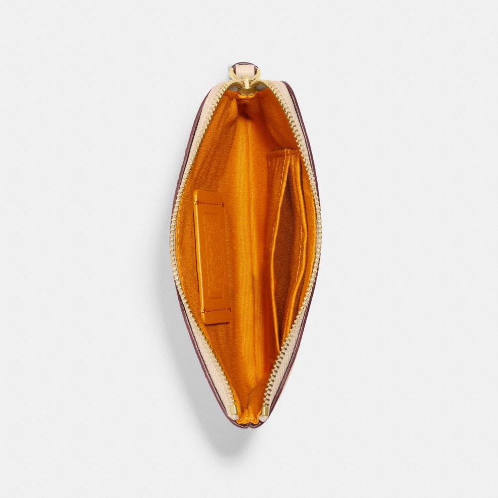 COACH X PEANUTS CORNER ZIP WRISTLET WITH SNOOPY AND FRIENDS MOTIF