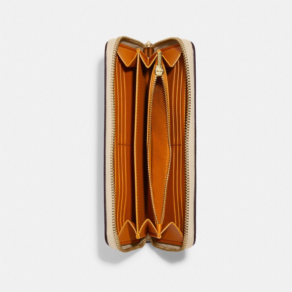 COACH X PEANUTS LONG ZIP AROUND WALLET WITH SNOOPY AND FRIENDS MOTIF