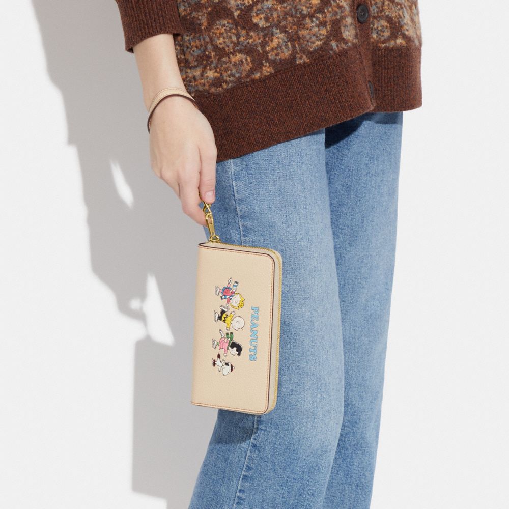COACH X PEANUTS LONG ZIP AROUND WALLET WITH SNOOPY AND FRIENDS MOTIF