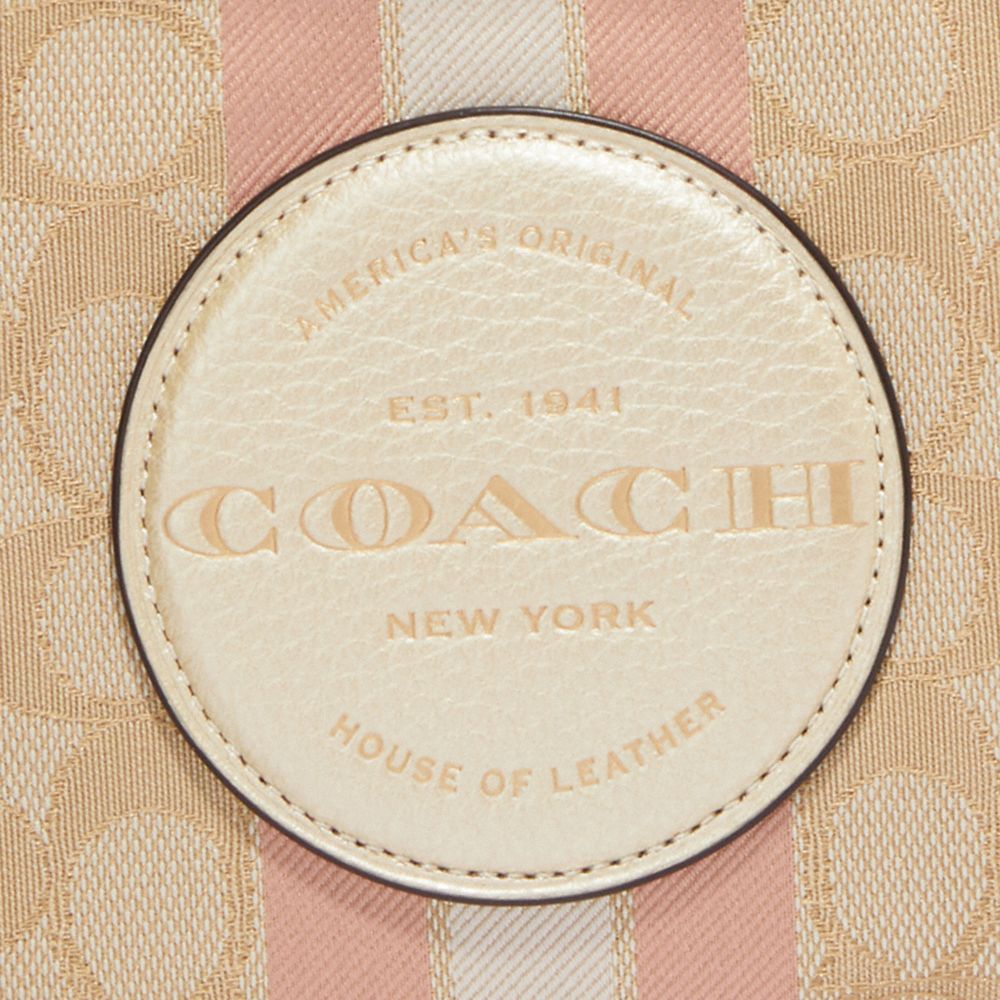 DEMPSEY LARGE CORNER ZIP WRISTLET IN SIGNATURE JACQUARD WITH STRIPE AND COACH PATCH