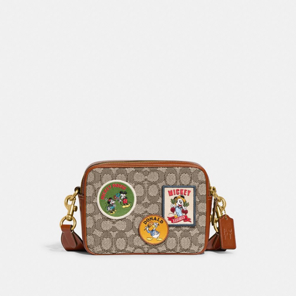 DISNEY X COACH FLIGHT BAG 19 IN SIGNATURE TEXTILE JACQUARD WITH PATCHES