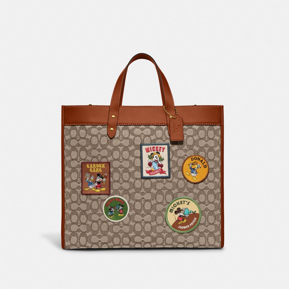 CG974 - Disney X Coach Field Tote 40 In Signature Textile Jacquard With Patches Cocoa Multi