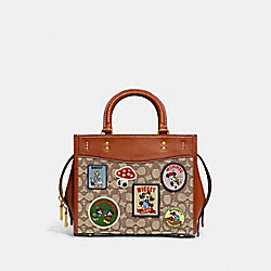 COACH CH416 Disney X Coach Rogue 25 In Signature Textile Jacquard With Patches BRASS/COCOA BURNISHED AMBER MULTI