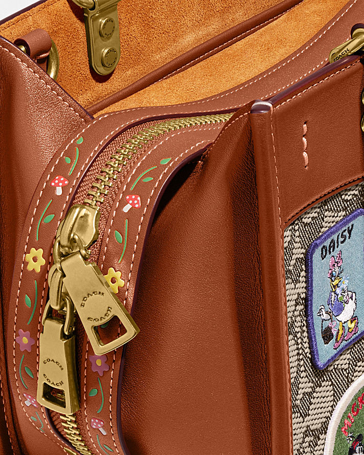 DISNEY X COACH ROGUE 25 IN SIGNATURE TEXTILE JACQUARD WITH PATCHES