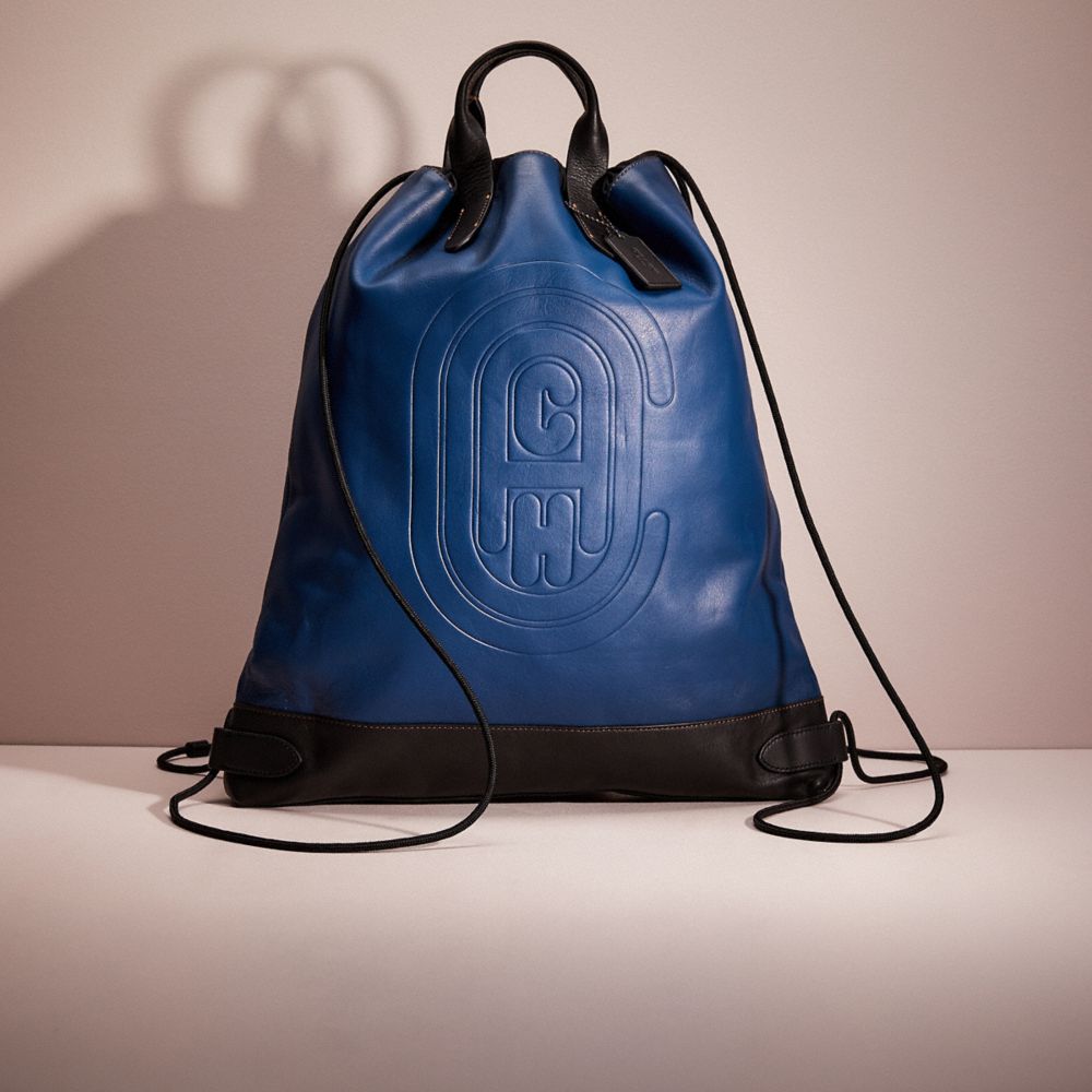 CL986 - Restored Academy Drawstring Backpack With Coach Patch Black Copper/True Blue