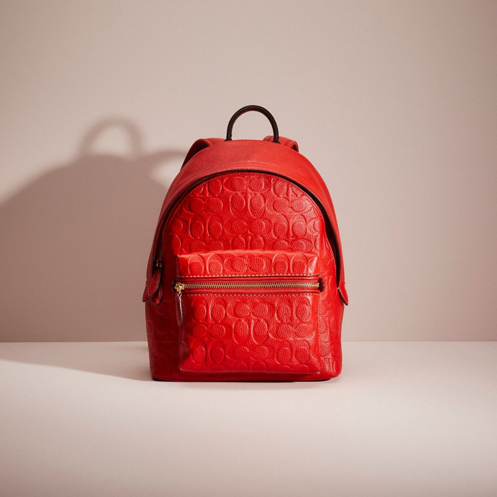 CM441 - Restored Charter Backpack 24 In Signature Leather Brass/Sport Red