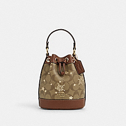 COACH CN679 Dempsey Drawstring Bucket Bag 15 In Signature Canvas With Star And Snowflake Print IM/KHAKI SADDLE/GOLD MULTI
