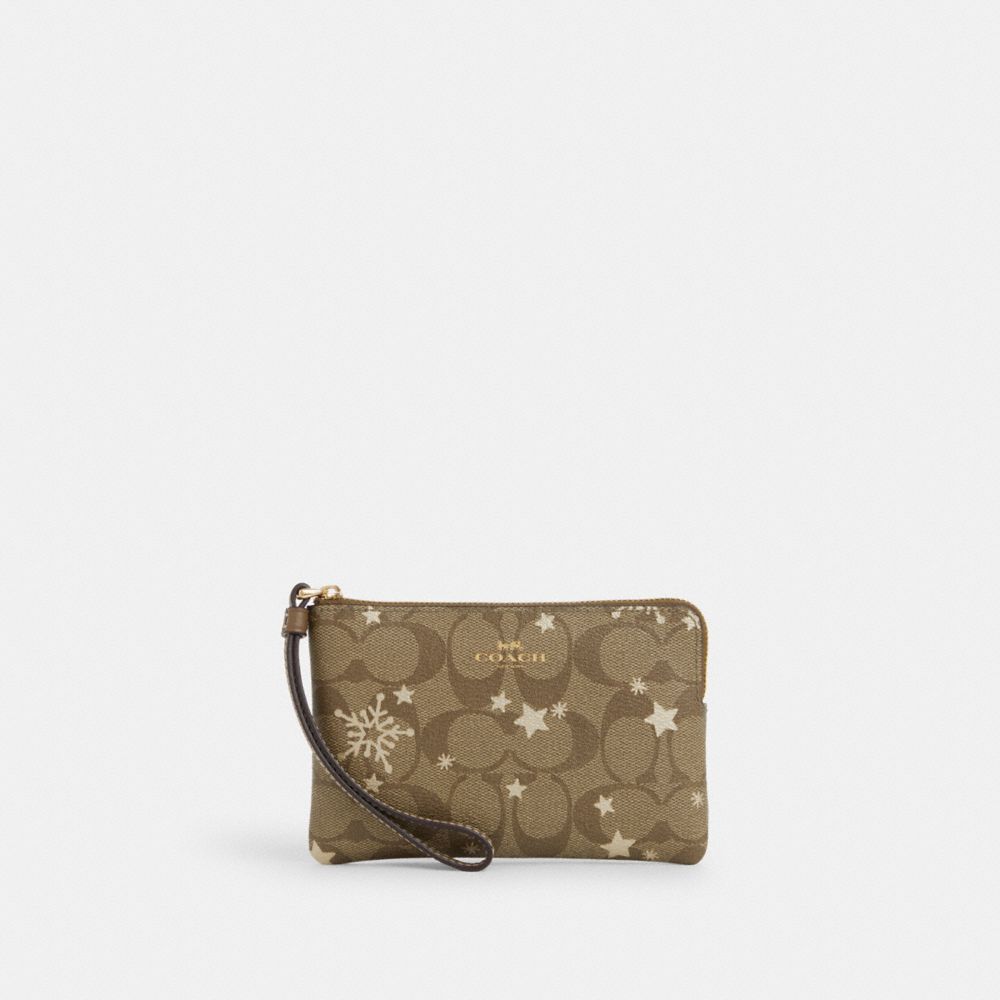 Corner Zip Wristlet In Signature Canvas With Star And Snowflake Print - CN756 - Im/Khaki Saddle/Gold Multi