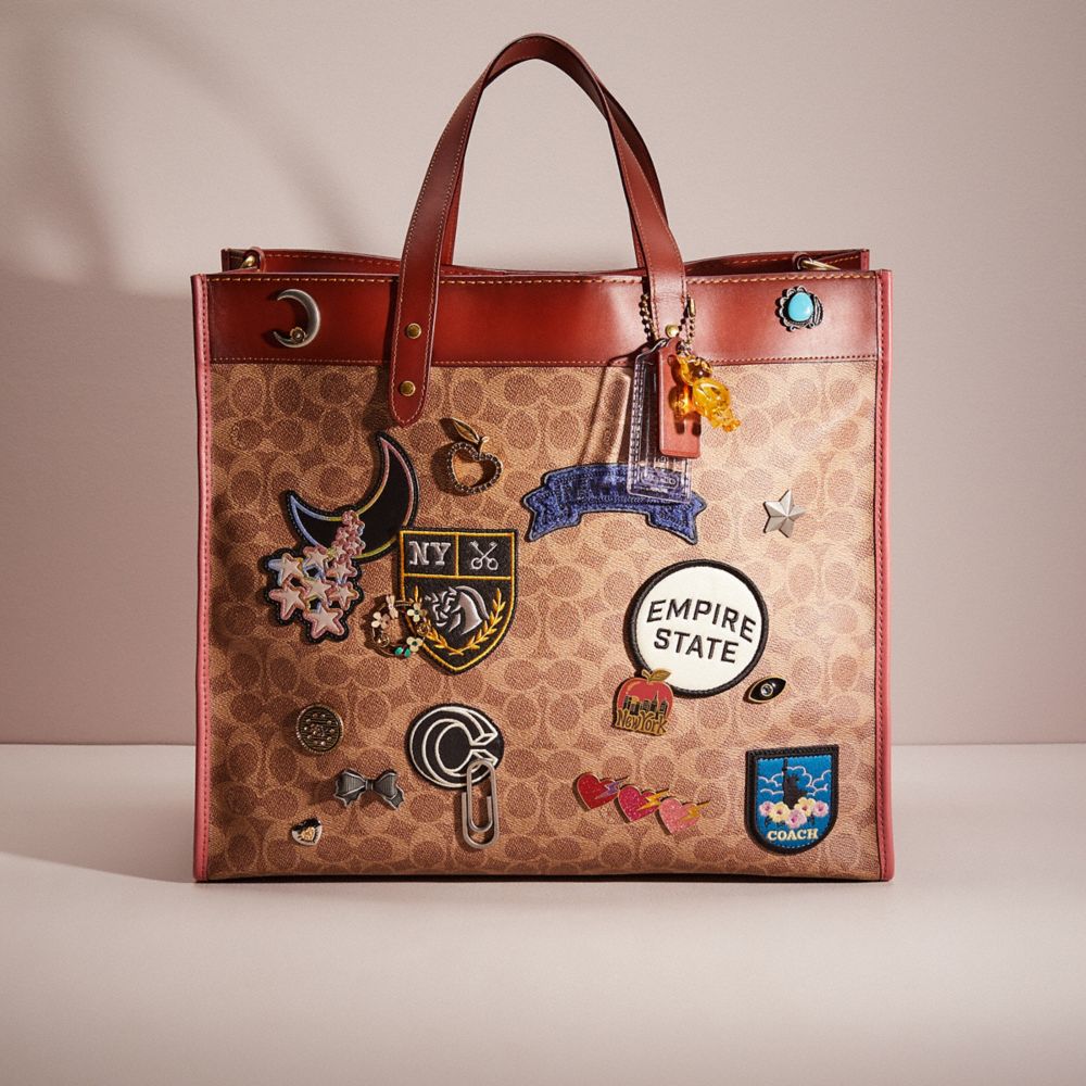 CN849 - Upcrafted Field Tote 40 In Signature Canvas With Souvenir Patches Brass/Tan Truffle Rust
