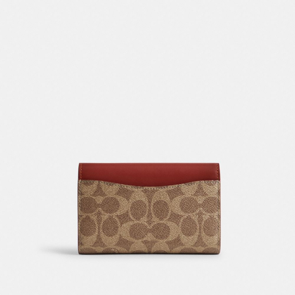 ESSENTIAL MEDIUM FLAP WALLET IN SIGNATURE CANVAS