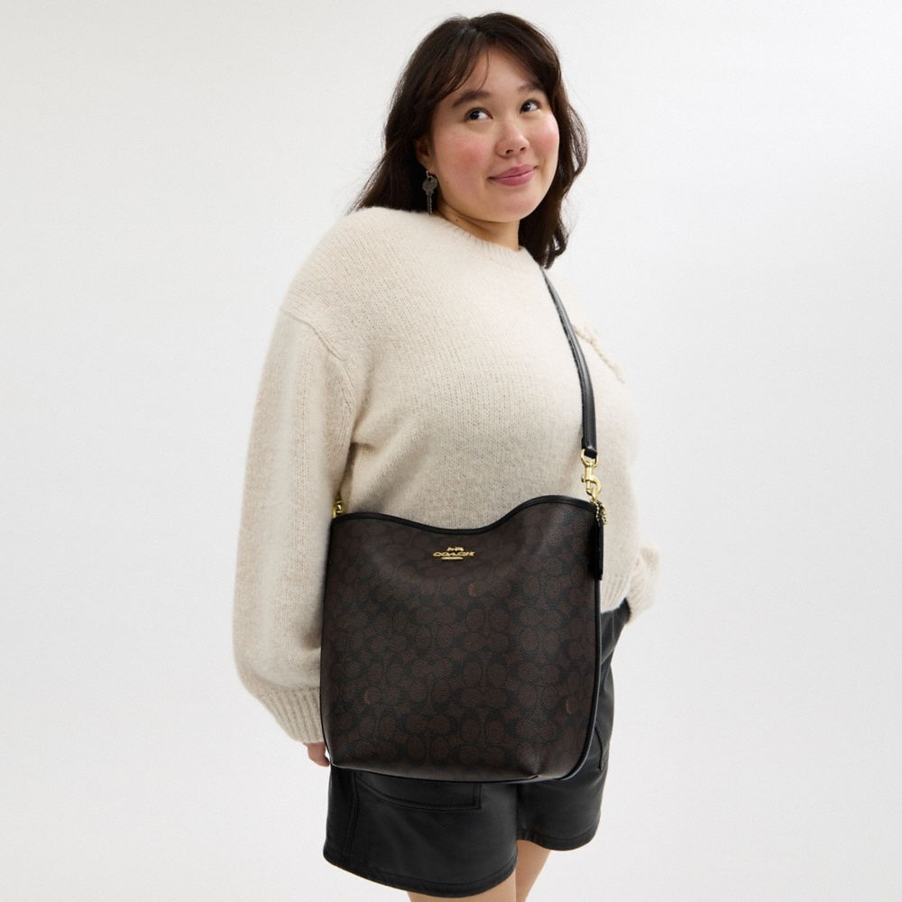 CITY LARGE BUCKET BAG IN SIGNATURE CANVAS