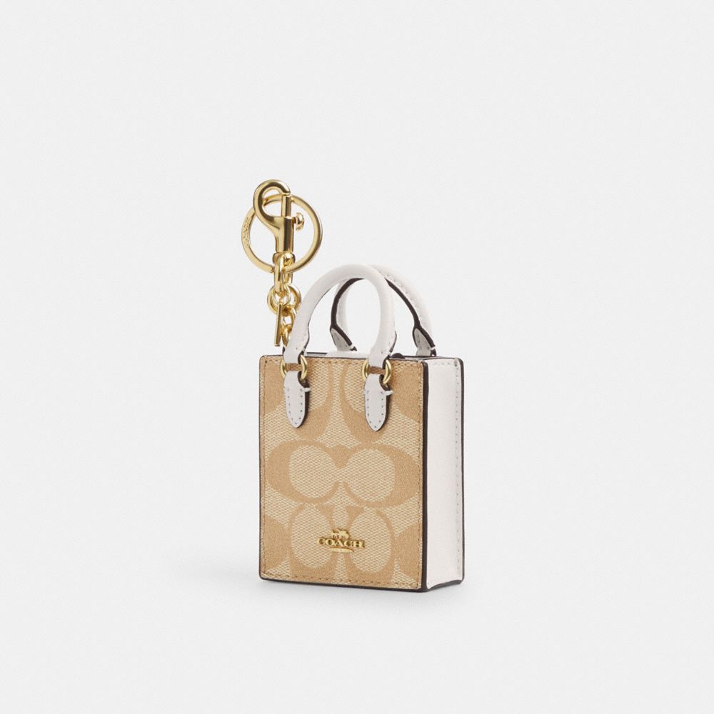 COACH CU281 North/south Mini Tote Bag Charm In Signature Canvas GOLD/LIGHT KHAKI CHALK