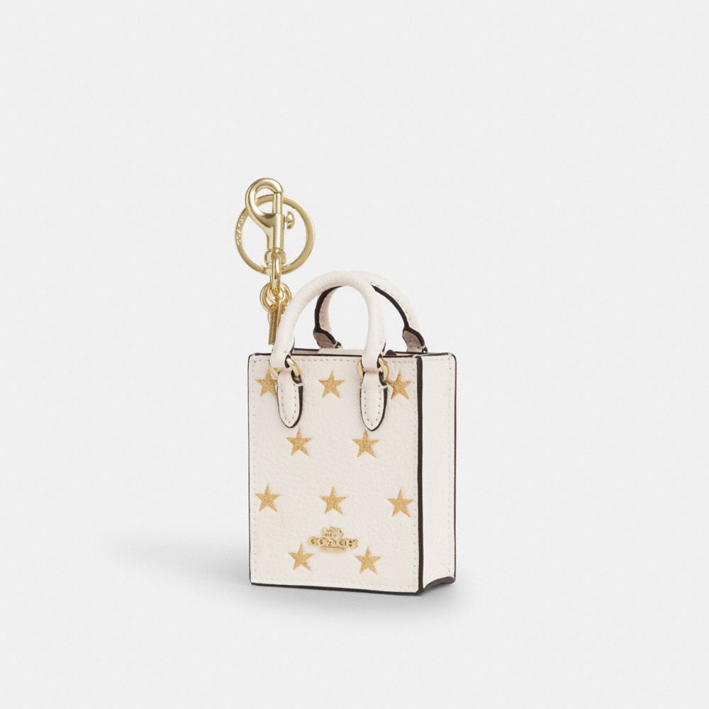 COACH CX074 North/south Mini Tote Bag Charm With Star Print GOLD/CHALK MULTI