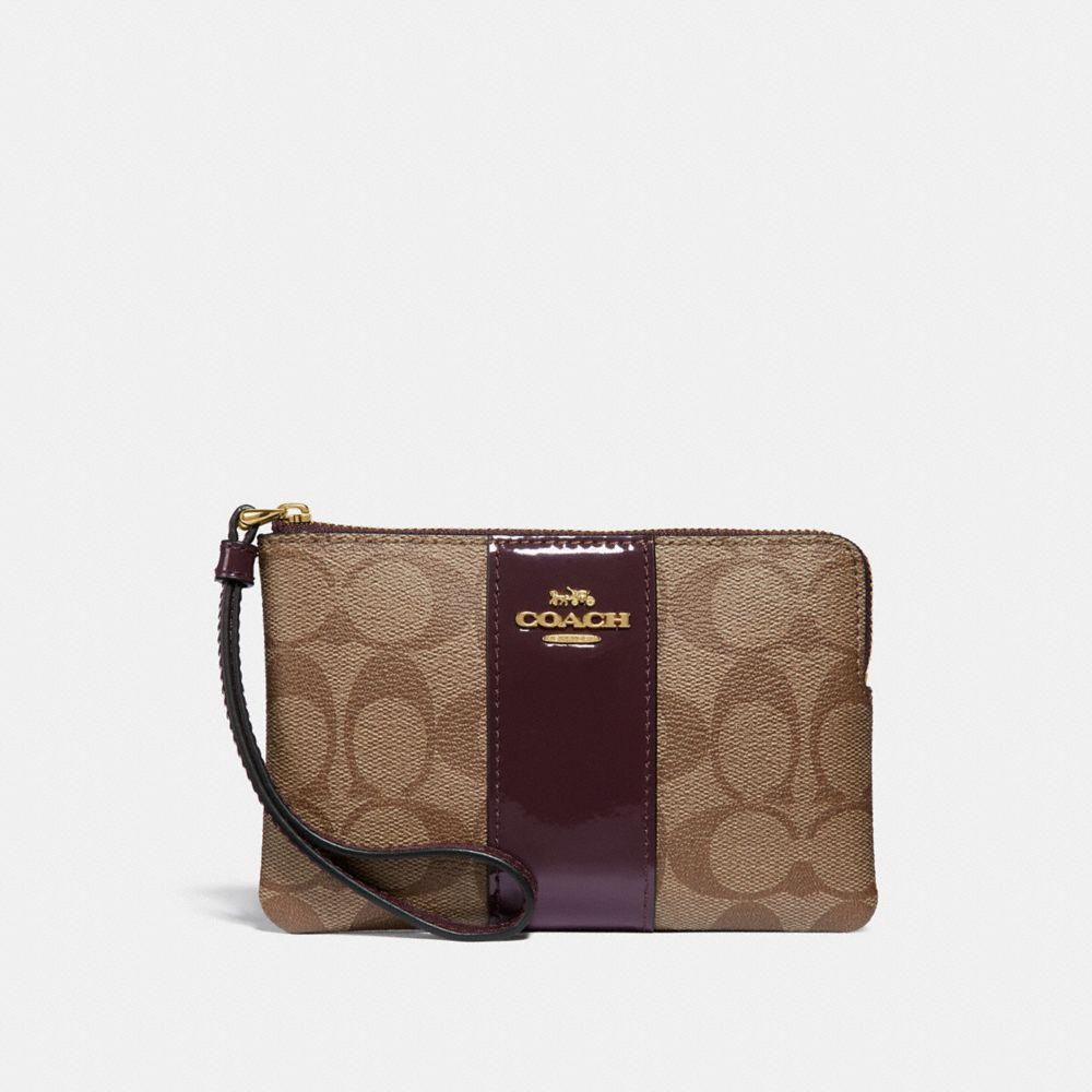 COACH CORNER ZIP WRISTLET IN SIGNATURE CANVAS - KHAKI/OXBLOOD/LIGHT GOLD - F34650