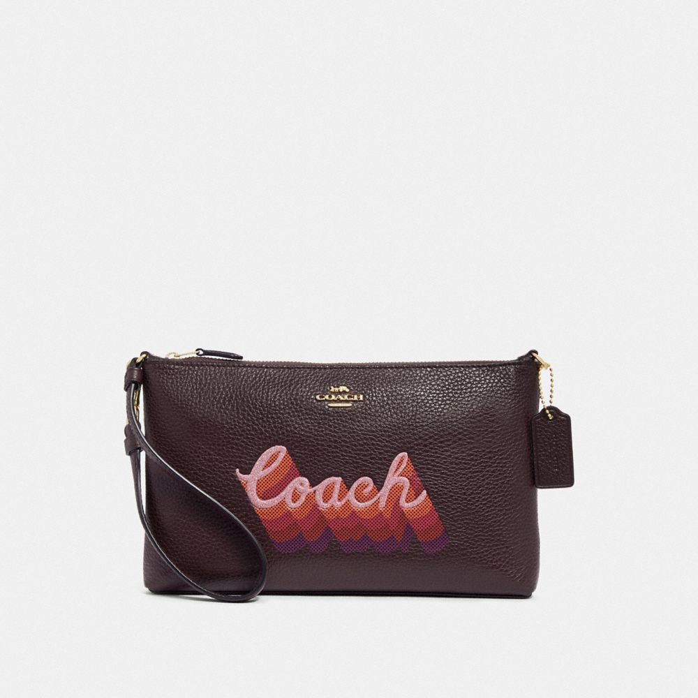 COACH LARGE WRISTLET 25 WITH NEON COACH SCRIPT - OXBLOOD MULTI/LIGHT GOLD - F38686