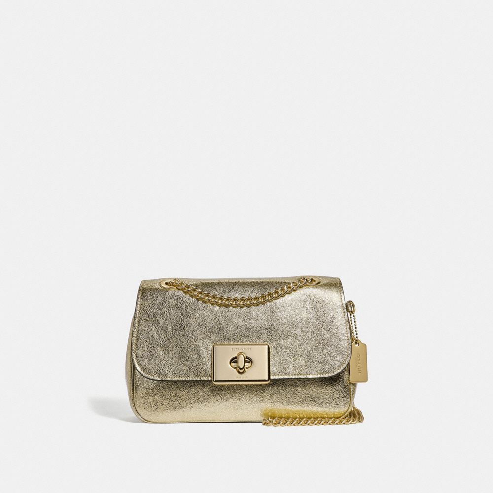 white and gold coach purse