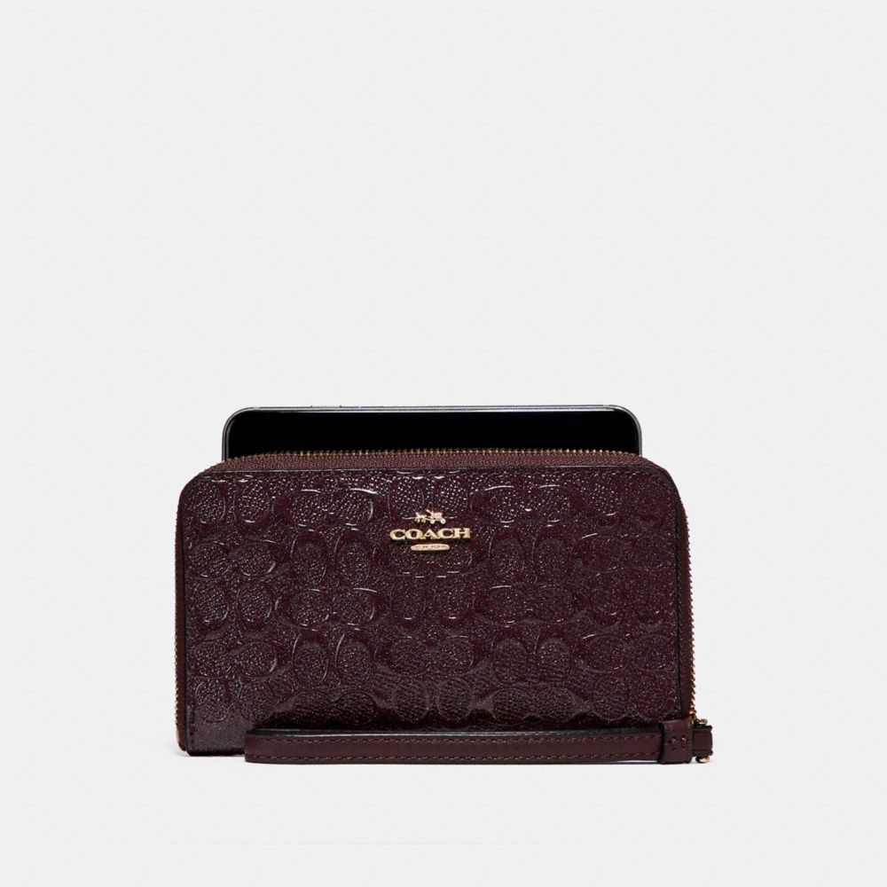 PHONE WALLET IN SIGNATURE DEBOSSED PATENT LEATHER - LIGHT GOLD/OXBLOOD 1 - COACH F57469