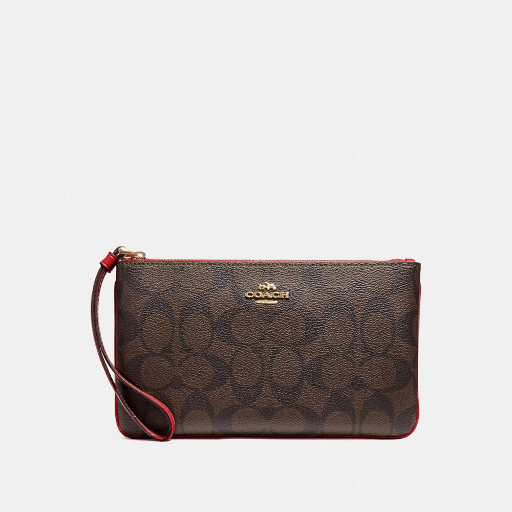 COACH LARGE WRISTLET IN SIGNATURE CANVAS - BROWN/TRUE RED/IMITATION GOLD - F58695