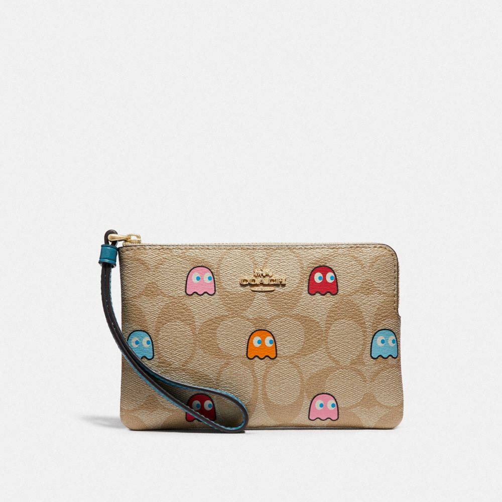 COACH CORNER ZIP WRISTLET IN SIGNATURE CANVAS WITH PAC-MAN GHOSTS PRINT - LIGHT KHAKI MULTI/GOLD - F73387