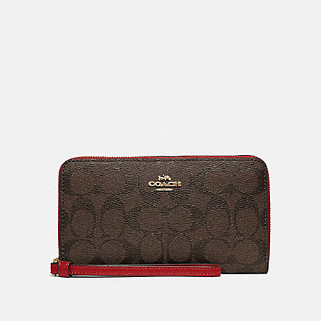 COACH LARGE PHONE WALLET IN SIGNATURE CANVAS - IM/BROWN TRUE RED - F73418