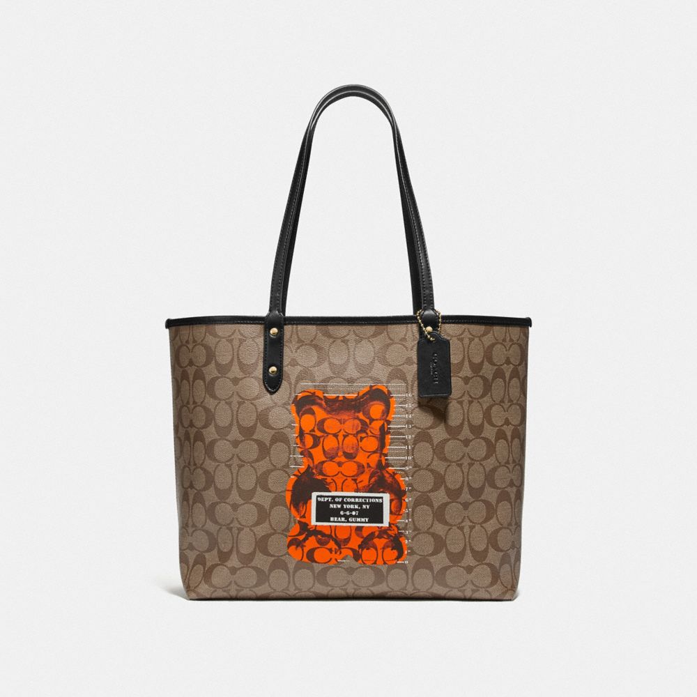 REVERSIBLE CITY TOTE IN SIGNATURE CANVAS WITH VANDAL GUMMY - KHAKI MULTI/BLACK/GOLD - COACH F76651