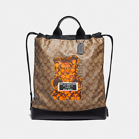 COACH F76805 TERRAIN DRAWSTRING BACKPACK IN SIGNATURE CANVAS WITH VANDAL GUMMY TAN/BLACK ANTIQUE NICKEL