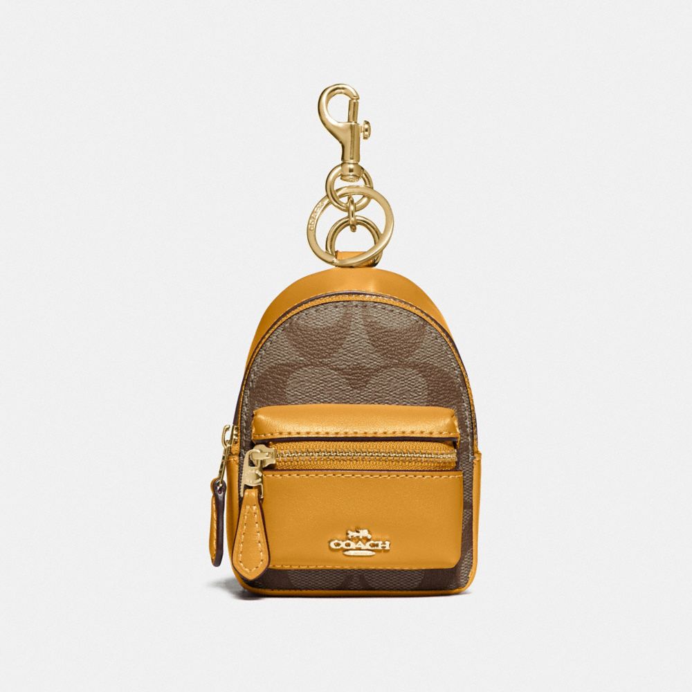 BACKPACK COIN CASE IN SIGNATURE CANVAS - KHAKI/MUSTARD YELLOW/GOLD - COACH F76937