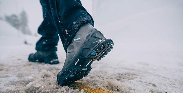 A man wearing shoes with Michelin outsoles in the snow.