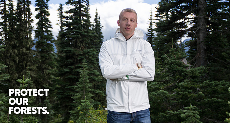 Image of Macklemore standing in a forest