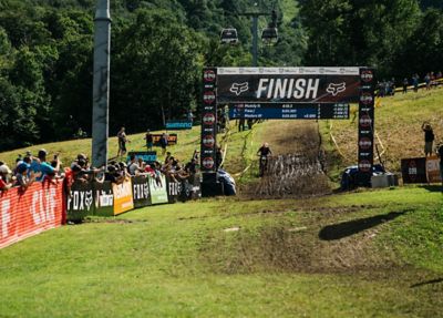 Mountain biker riding through the finish line at the Fox US Open of Mountain Bike