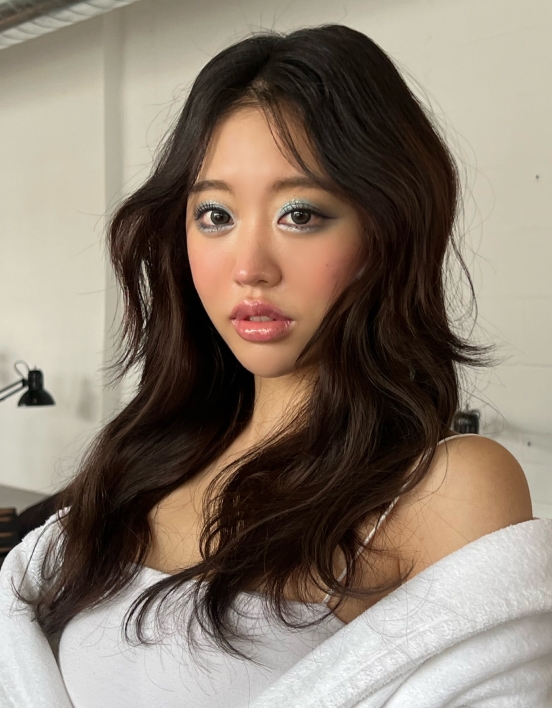 A close-up of Jessica wearing a white robe and showing off her mermaid makeup.