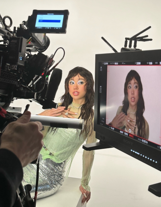 A close-up of a monitor on set showing Jessica  posing for the camera.