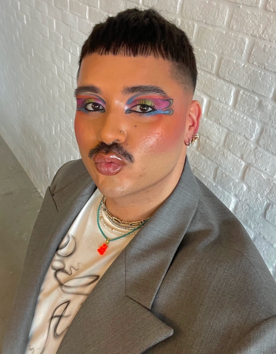 Michael making a kissing face for the camera, pouting his glossy lips.