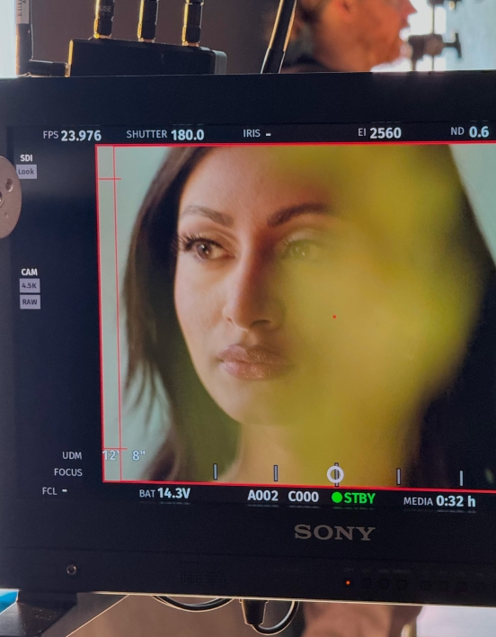 A close-up of a monitor on set showing Krishna posing for the camera.