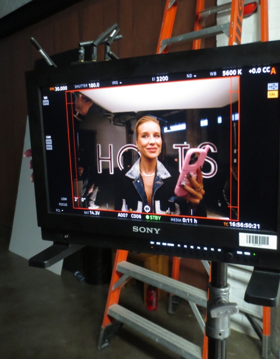 A close-up of a monitor on set showing Emy-Jade posing for the camera.