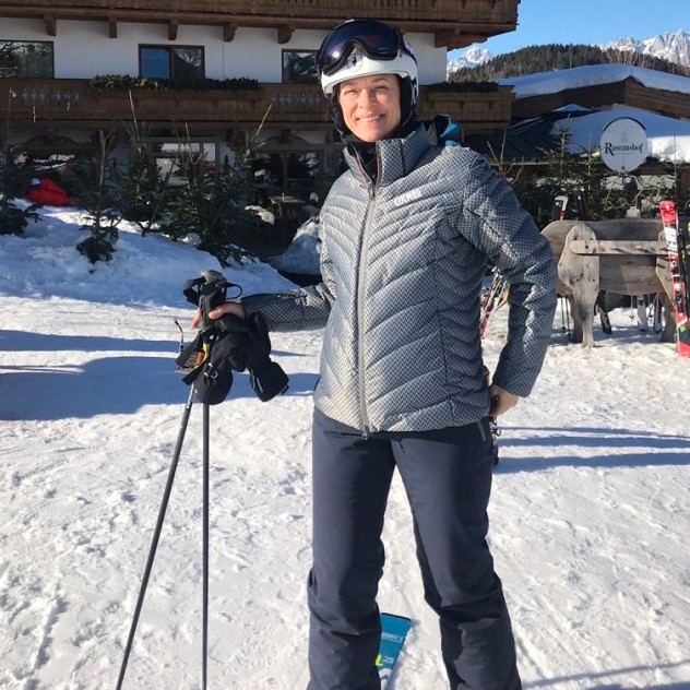 Christina outside of a ski chalet, geared up to hit the slopes.